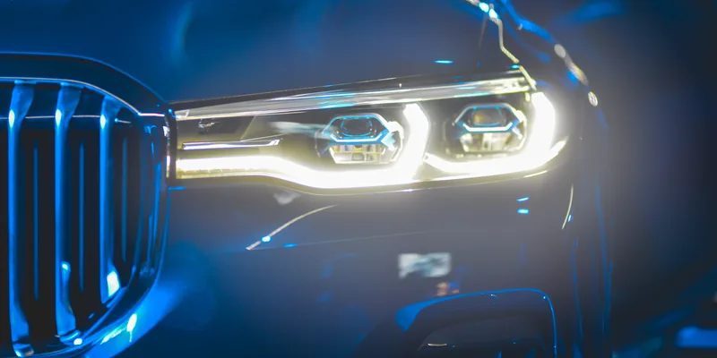 Close-up of a headlight and wheel on a car finished with the Graphene Select wash